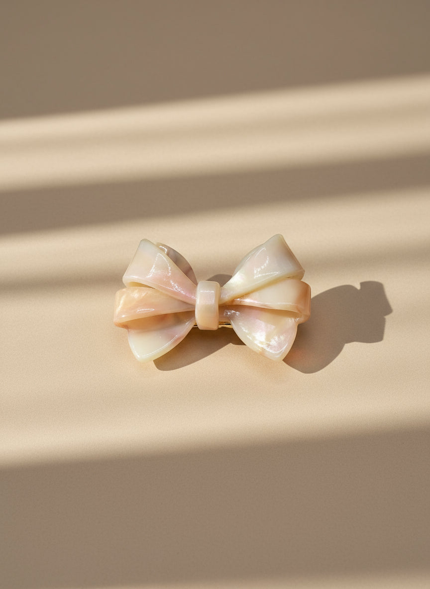 Blush ombré aztec bow hair clip on a beige background, only at petite murmure