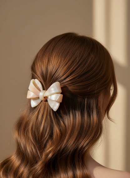 Brunette Hair model wears Blush ombré aztec bow hair clip against a neutral background, only at petite murmure