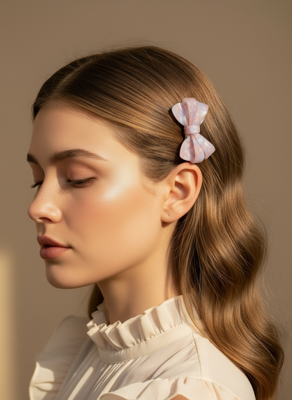 Woman with a Blush ombré aztec bow hair clip in her hair against a neutral background, she is ready for party, gathering , and weddings. only at petite murmure