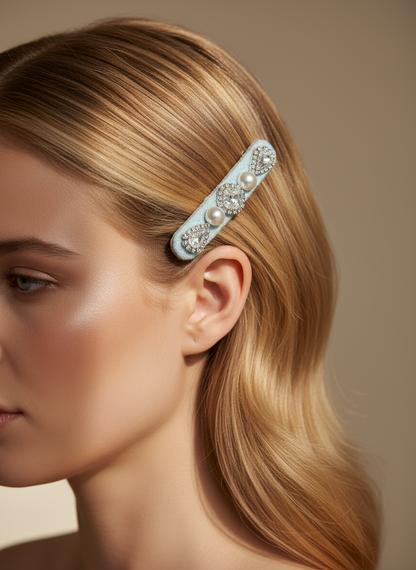 Woman wearing a handmade decorative lace hair clip with pearls and Swarovski crystals on a soft neutral background. Only at Petite Murmure 
