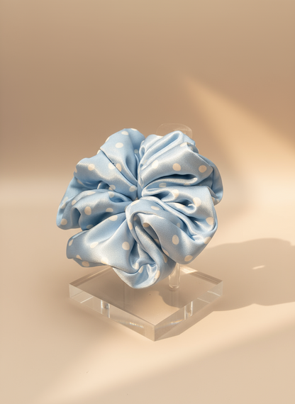 Babyblue handcrafted 30mm mulberry silk scrunchie with white polka dots with white polka dots on a beige background