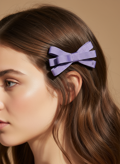 Woman with a purple bow in her hair against a beige background
