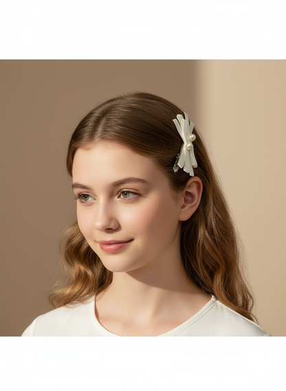Young girl with a decorative cream white hair clip with layered ribbons and pearls on a beige background