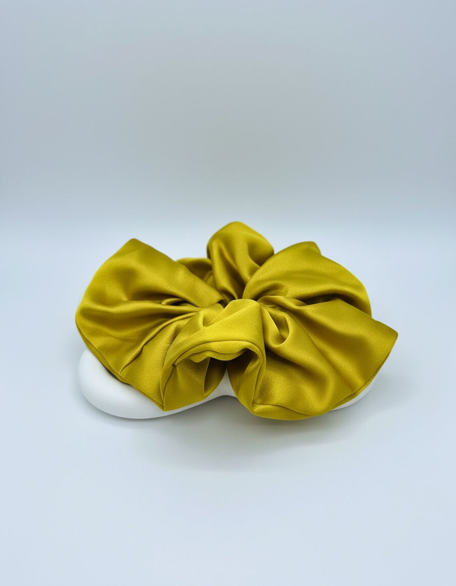 Mustard Yellow handcrafted 30mm mulberry silk scrunchie on a white surface with a light gray background