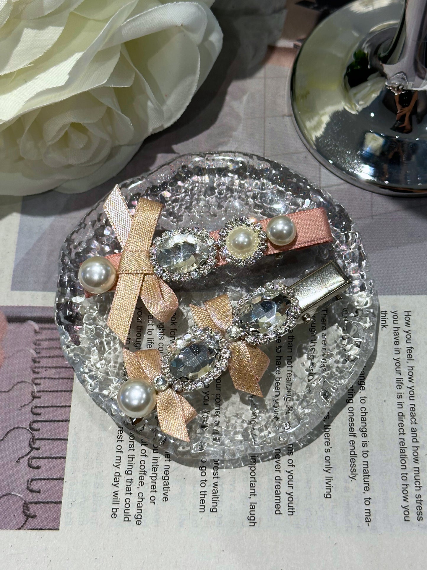 Decorative hair clips with ribbon. pearls and Swarovski crystals embellished hair clips on a textured crystal surface