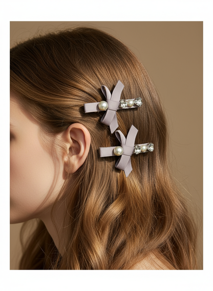 Hair clips with bows ,Swarovski crystals and pearls on a model's hair against a beige background