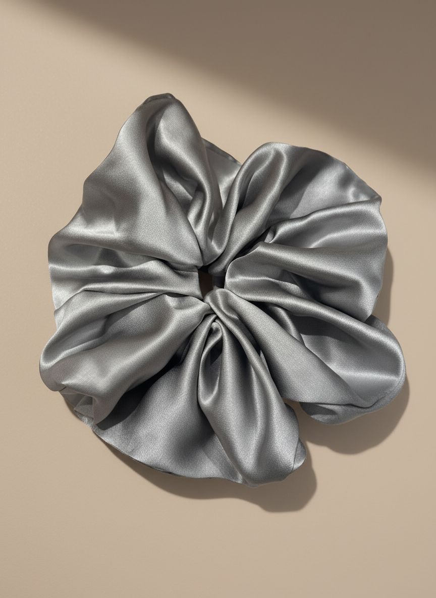 Silver Gray  handcrafted 30mm mulberry silk scrunchie on a beige background