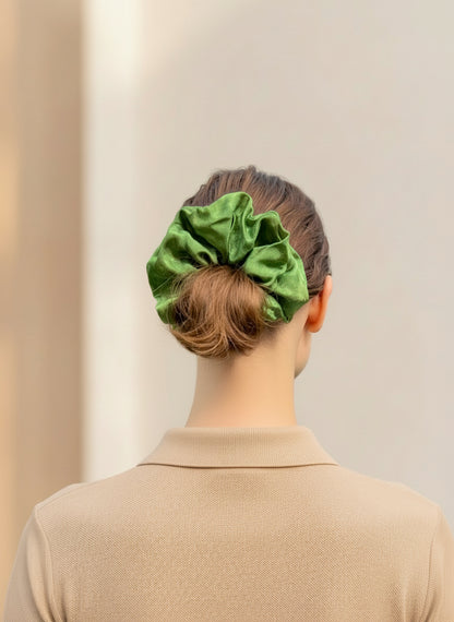 Person wearing a green Handmade Green Tea Scented Mulberry Silk Scrunchies  with a neutral background