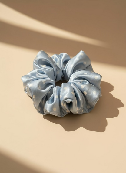 Babyblue handcrafted 30mm mulberry silk scrunchie with white polka dots on a beige background