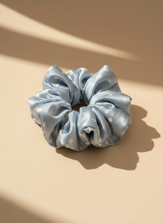 Babyblue handcrafted 30mm mulberry silk scrunchie with white polka dots on a beige background