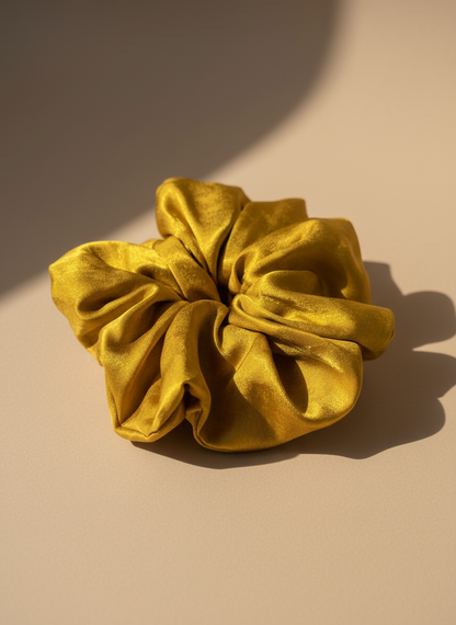 Gold Handmade Green Tea Scented Mulberry Silk Scrunchies on a beige background