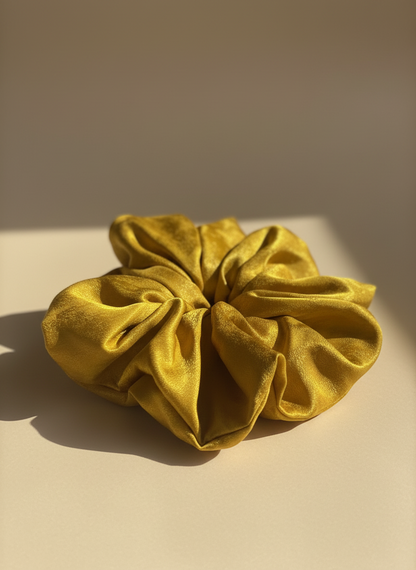 Gold Handmade Green Tea Scented Mulberry Silk Scrunchies on a beige surface with a neutral background