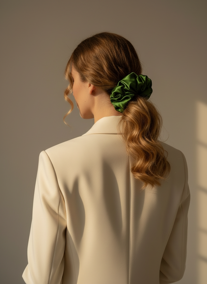 Woman with a Green handmade ripply mulberry silk scrunchie with natural rose scented in her hair wearing a beige blazer against a neutral background