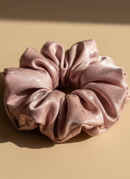 Pink handmade mulberry silk scrunchie with peony aroma scent on a beige background