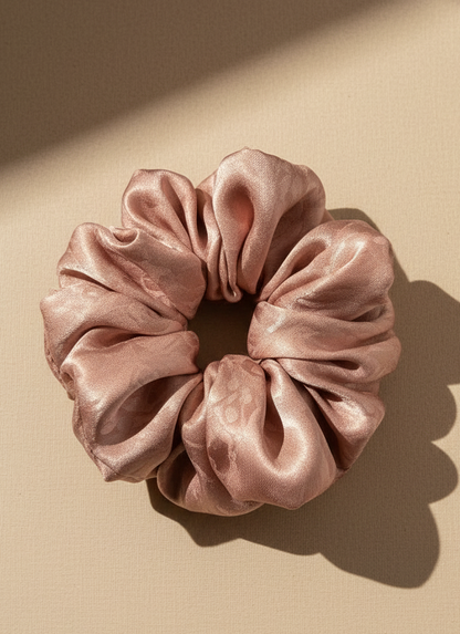 Pink Pink handmade mulberry silk scrunchie with peony aroma scent on a beige background