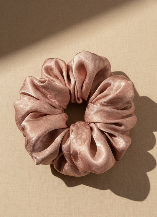 Pink Pink handmade mulberry silk scrunchie with peony aroma scent on a beige background