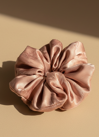 Pink handmade rose aromatic scented mulberry silk scrunchie on a beige background