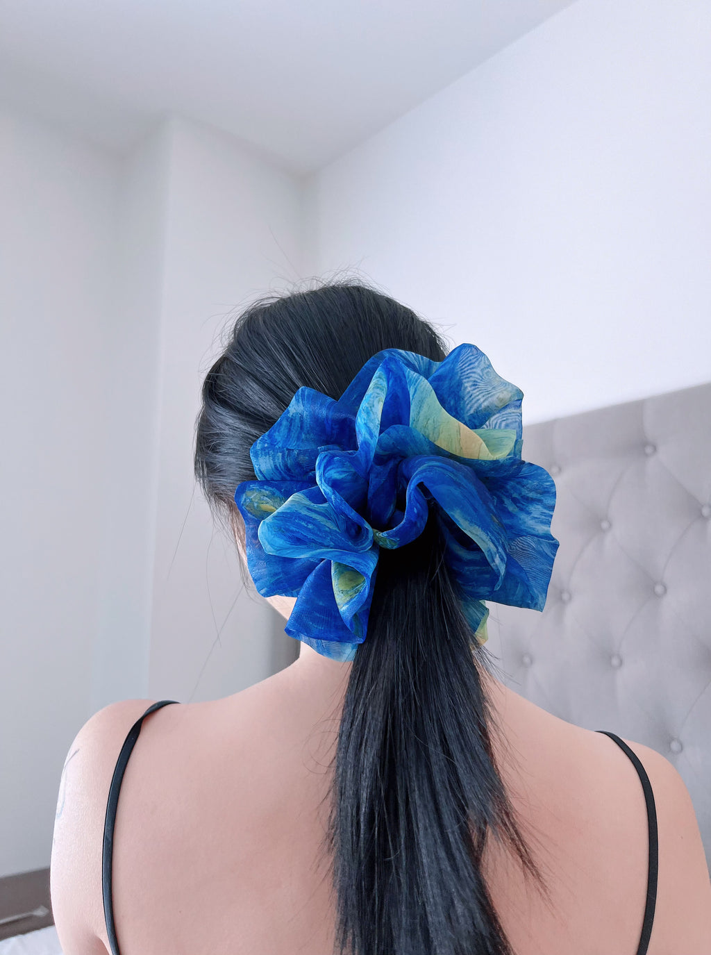 Female model with a a large blue organza scrunchies in her hair that inspired by Van Gogh's  the Starry Night, only at Petite 
Murmure,against a neutral background