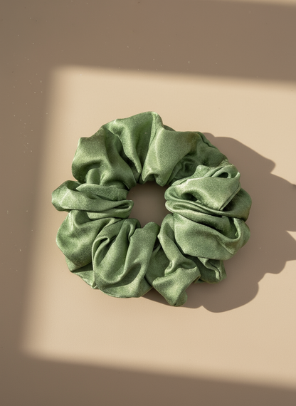 Green Handmade Green Tea Scented Mulberry Silk Scrunchies on a beige background