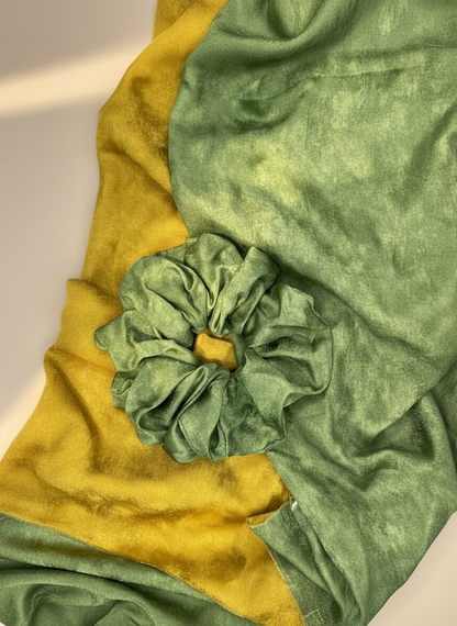 Green Handmade Green Tea Scented Mulberry Silk Scrunchies and green and yellow green tea aromatic ripply mulberry silk fabric with a flower-like knot on a white background
