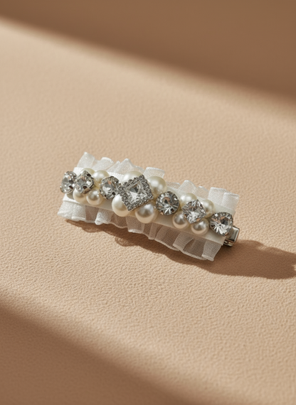 A hair clip with Swarovski crystals and pearls embellished and silky organza  on a beige background. Only at Petite Murmure