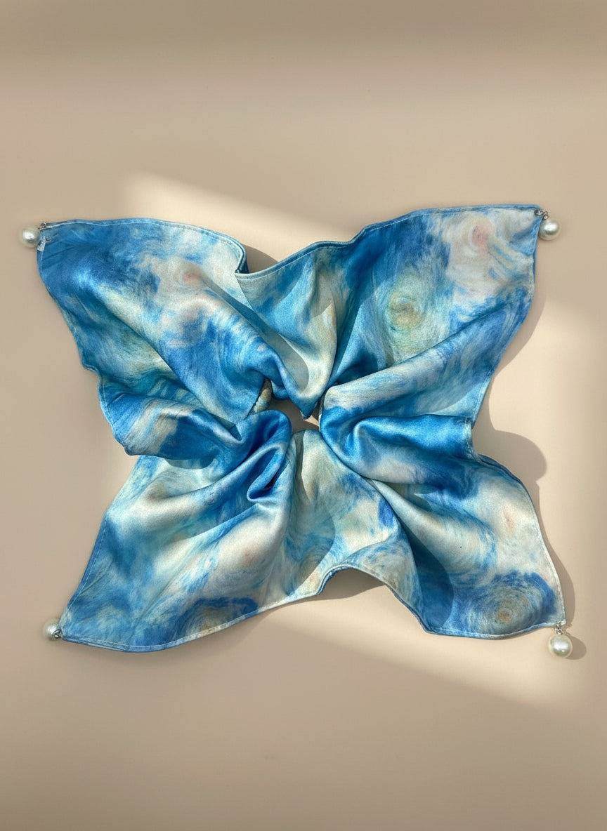 Blue and white tie-dye satin square handkerchief scrunchie with pearl detail  on a beige background, only at petitemurmure.com