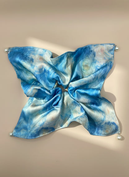 Blue and white tie-dye satin square handkerchief scrunchie with pearl detail  on a beige background, only at petitemurmure.com