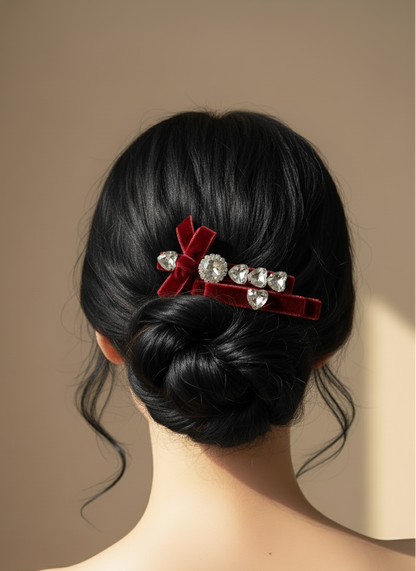 Black hair bun with Two red velvet hair clips with Swarovski crystal stones on a neutral background