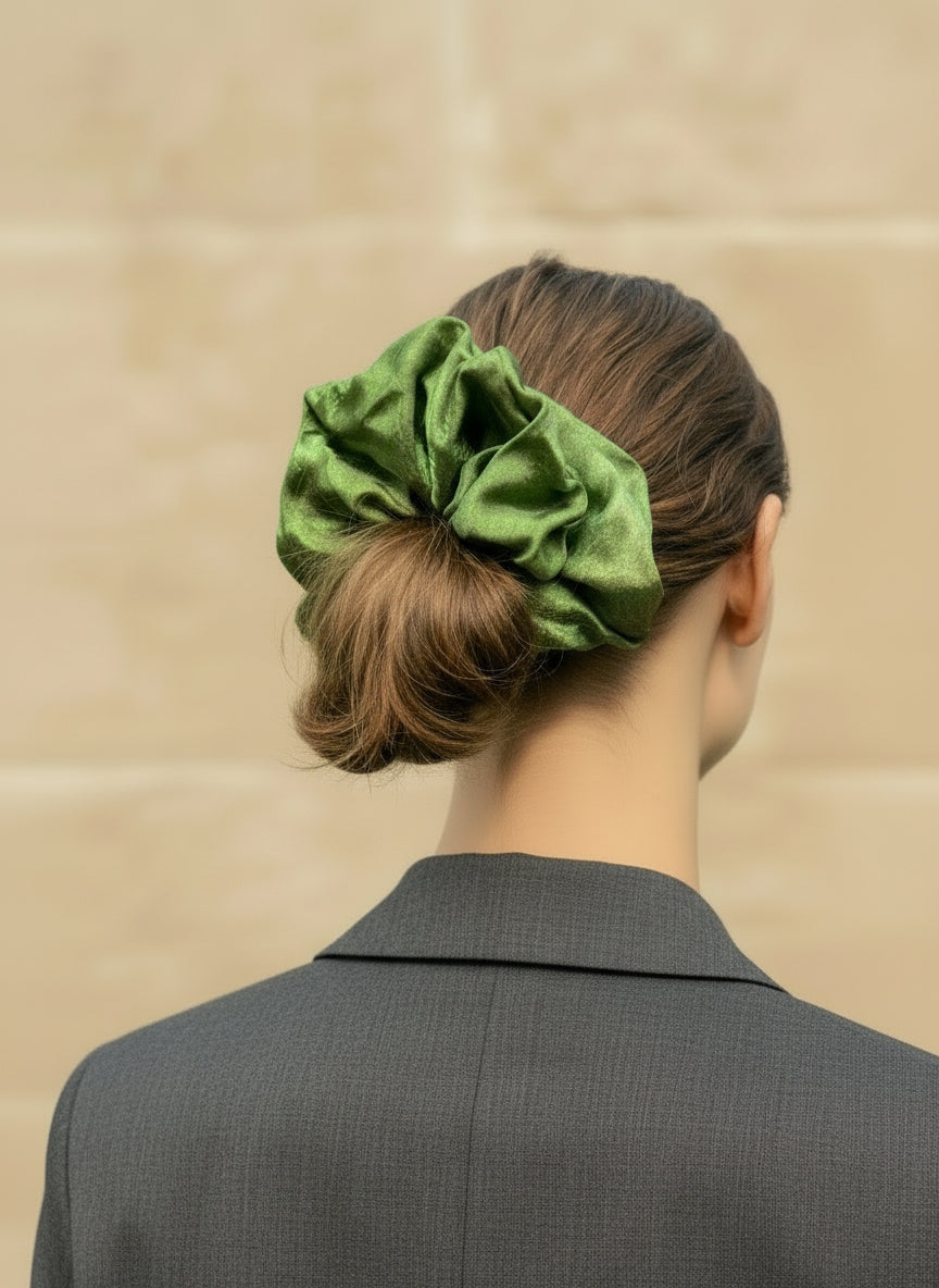 Person wearing a green Handmade Green Tea Scented Mulberry Silk Scrunchies  in their hair against a beige background