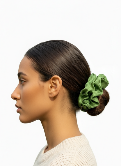 Woman with a green Handmade Green Tea Scented Mulberry Silk Scrunchies in her hair on a white background