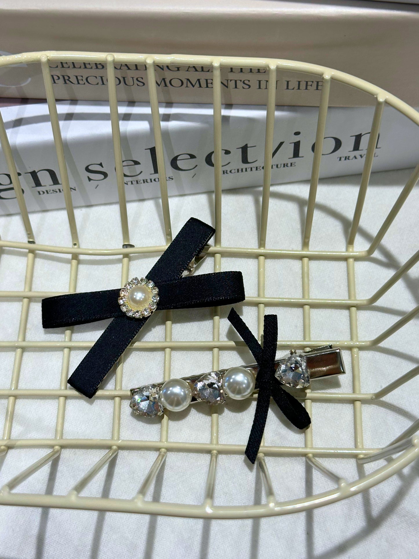 Black Set of hair accessories including a hair clip with black ribbons , Swarovski crystals and pearls with pearl accents on a wire basket