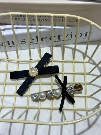 Black Set of hair accessories including a hair clip with black ribbons , Swarovski crystals and pearls with pearl accents on a wire basket
