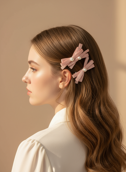 Woman with long hair wearing Two pink hair bows with layered bows and pearl centers against a beige background, it holds her hair very smoothly